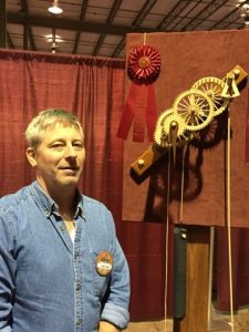 Andy Chew with one of his award-winning gear clocks.