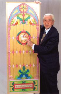 Joseph Lucania shows off a stained glass window he created for his church