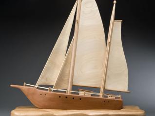 Our designer, Jon Deck, was so impressed with George's sailboat that he set out to make one himself. Jon used redwood for the hull and poplar for the sails.