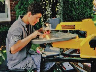 Sage, at age 15, cuts ornaments on his DeWalt scroll saw.