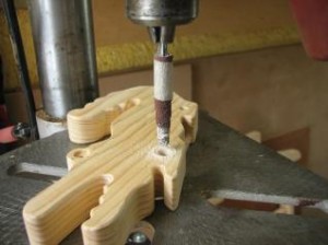Use a cone of sandpaper in a drill press to quickly clean up the edges of a drilled hole.