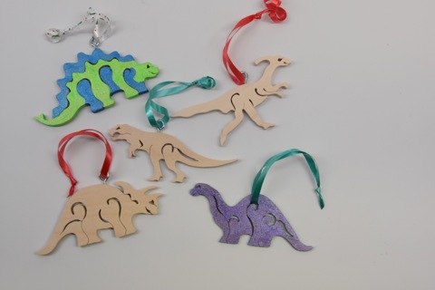 Judy created ornaments from her dinosaur toy patterns! She embellished them with what she calls "faux fretwork," which involves drawing some fancy lines on the pattern and cutting in from the edge.